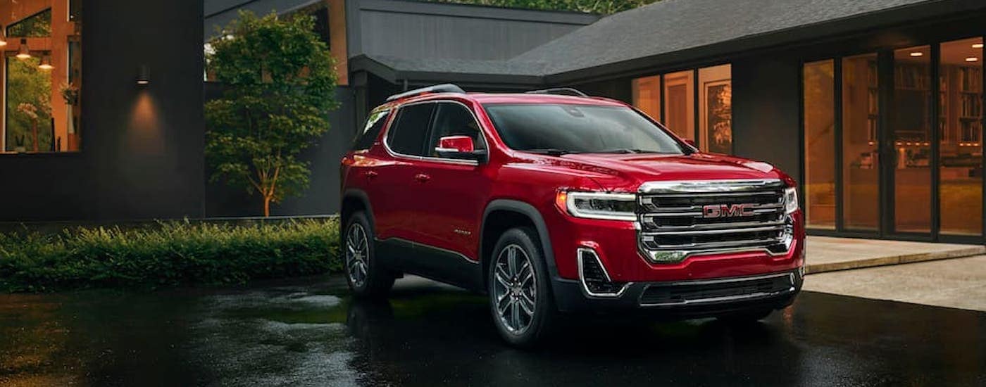 A red 2023 GMC Acadia is shown from the front at an angle after leaving a GMC dealer.