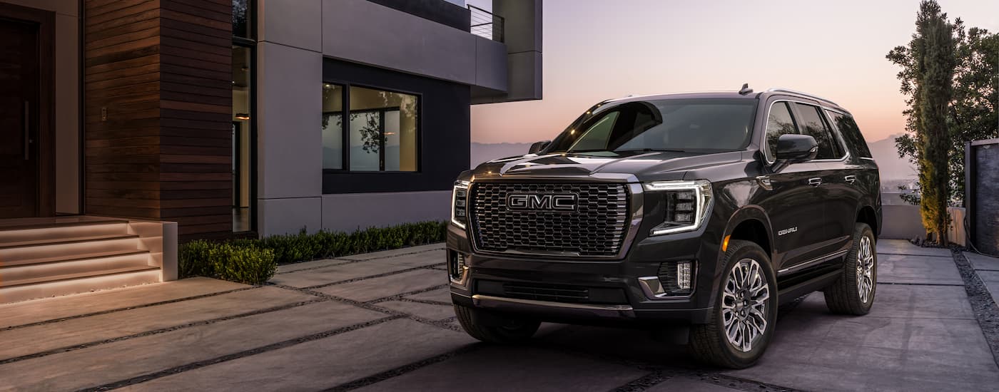 A black 2023 GMC Yukon Denali Ultimate is shown from the front at an angle.